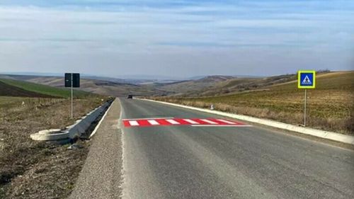 Trecere de pietoni apărută pe un câmp din județul Iași. Localnici: Ăla e traseul gândacului de bălegar. Ar trebui și un semafor / Primar: Executantul lucrării a motivat că la 20 de metri este stație de transport public pentru cei care vin din satele vecine