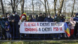 Câțiva participanți la parada de Ziua Națională au afișat un banner critic la adresa președintelui Iohannis și a cooptării PSD la guvernare: „Iliescu a chemat minerii. Iohannis a chemat PSD-ul”