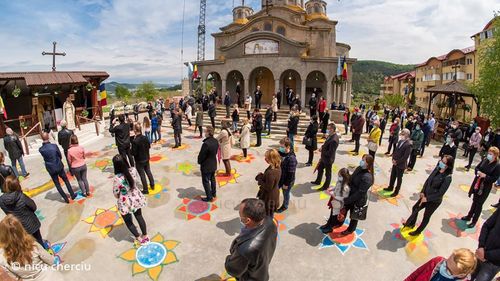 Soluție inedită a unui preot din Cluj pentru a respecta distanțarea fizică la slujbă: a desenat împreună cu voluntarii 150 de flori în curtea bisericii